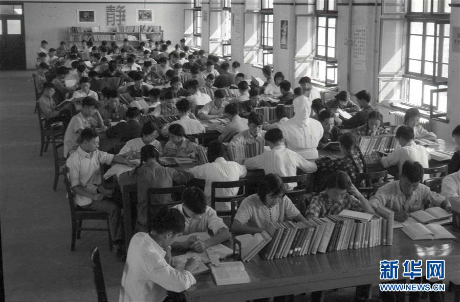 从开始西迁至1956年9月，包括815名教职工、3900余名学生在内的6000多名交大人汇聚古都西安，经紧锣密鼓建设而成的新校园也从一片麦田中拔地而起。图为1959年，学生们在西迁后的交大校园图书馆阅览室内学习（资料照片）。新华网发
